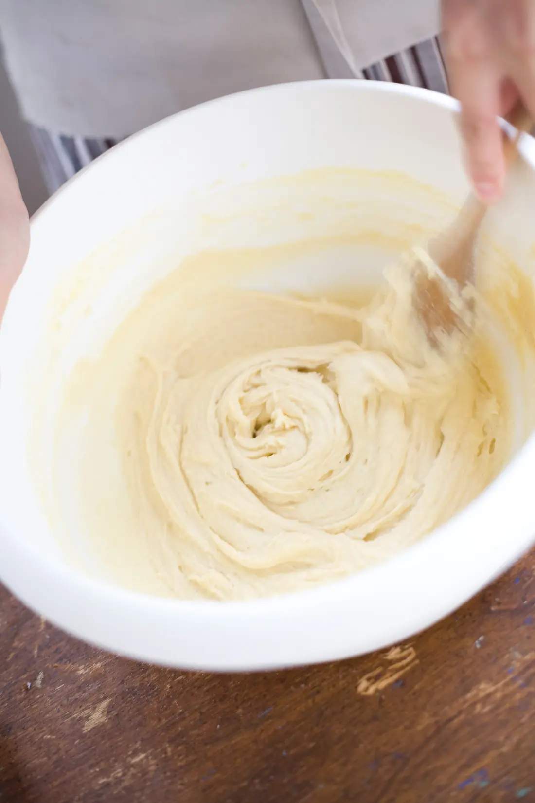 Cake batter being mixed in a white bowl