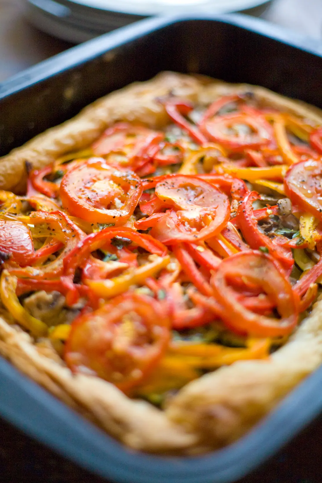A baked tomato and pepper tart, golden at the edges